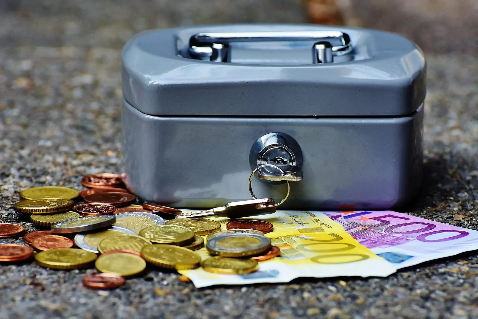 A cash box filled with euro coins and banknotes